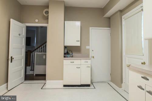 2504 Queen Anne Road Baltimore, MD 21216 - Photo 12 of 36 a spacious bathroom with a granite countertop sink and a mirror