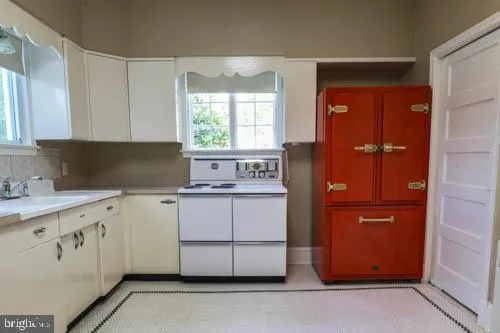 a kitchen with granite countertop white cabinets and sink
