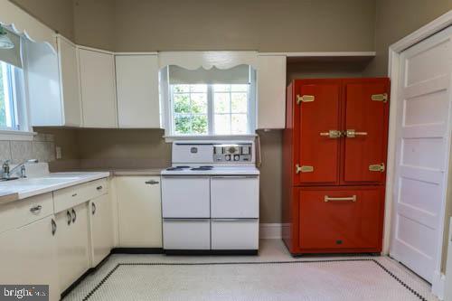 2504 Queen Anne Road Baltimore, MD 21216 - Photo 15 of 36 a kitchen with granite countertop white cabinets and sink