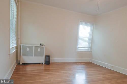 2504 Queen Anne Road Baltimore, MD 21216 - Photo 16 of 36 a view of an empty room with wooden floor and a window
