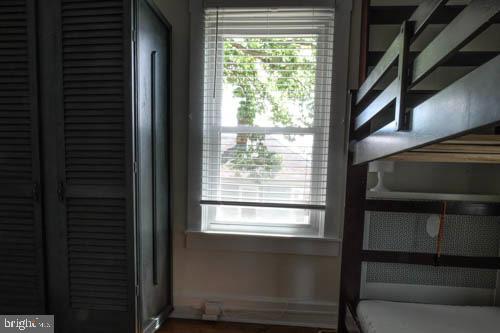 2504 Queen Anne Road Baltimore, MD 21216 - Photo 19 of 36 a view of an empty room with wooden floor and windows
