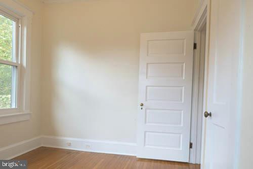 2504 Queen Anne Road Baltimore, MD 21216 - Photo 20 of 36 a view of an empty room with wooden floor and a window