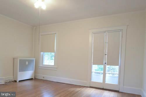 2504 Queen Anne Road Baltimore, MD 21216 - Photo 24 of 36 an empty room with wooden floor and windows