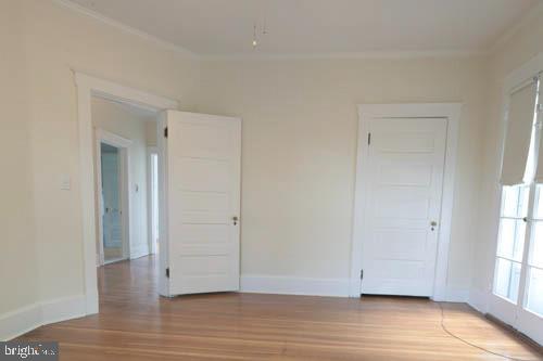 2504 Queen Anne Road Baltimore, MD 21216 - Photo 25 of 36 an empty room with wooden floor and windows