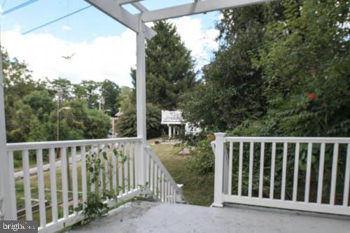 2504 Queen Anne Road Baltimore, MD 21216 - Photo 30 of 36 a view of a wooden fence and trees around