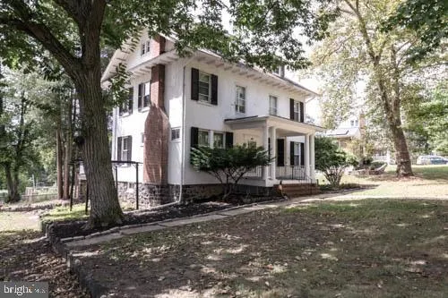 a view of a white house with a yard