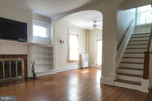 2504 Queen Anne Road Baltimore, MD 21216 - Photo 4 of 36 a view of a livingroom with wooden floor and fireplace