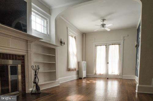 2504 Queen Anne Road Baltimore, MD 21216 - Photo 5 of 36 a view of an empty room with a window and wooden floor