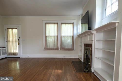2504 Queen Anne Road Baltimore, MD 21216 - Photo 6 of 36 a view of an empty room with wooden floor and a window