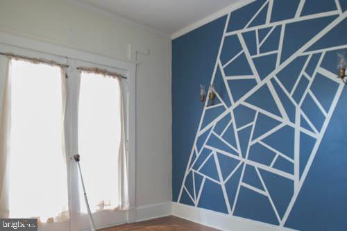 2504 Queen Anne Road Baltimore, MD 21216 - Photo 8 of 36 a view of an empty room with wooden floor and a window