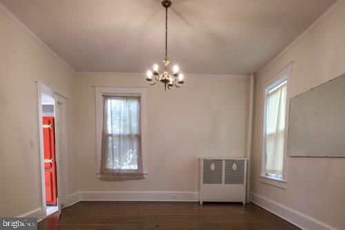 2504 Queen Anne Road Baltimore, MD 21216 - Photo 9 of 36 a living room with furniture and a chandelier