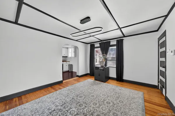 a view of a room with wooden floor and sliding window