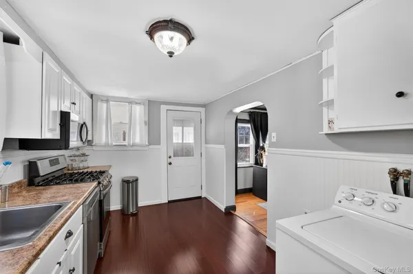 a kitchen with a refrigerator and a sink