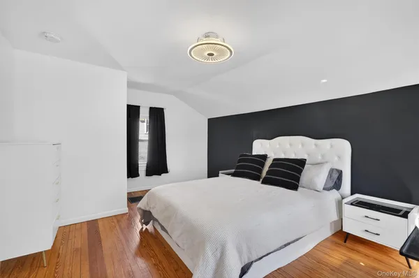 a bedroom with a bed and a lamp