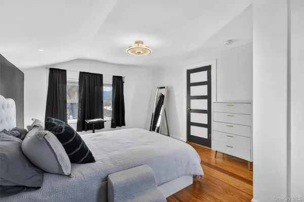 a bedroom with a bed next to a large window