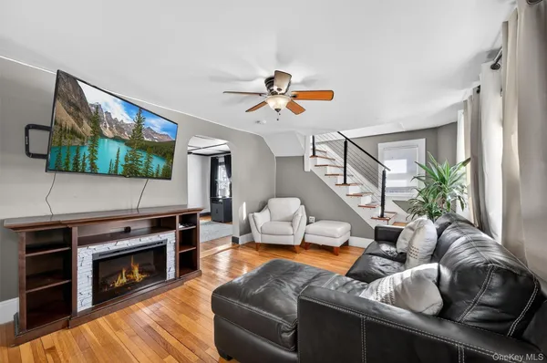 a living room with furniture fireplace and flat screen tv