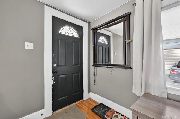 a view of an entryway with wooden floor