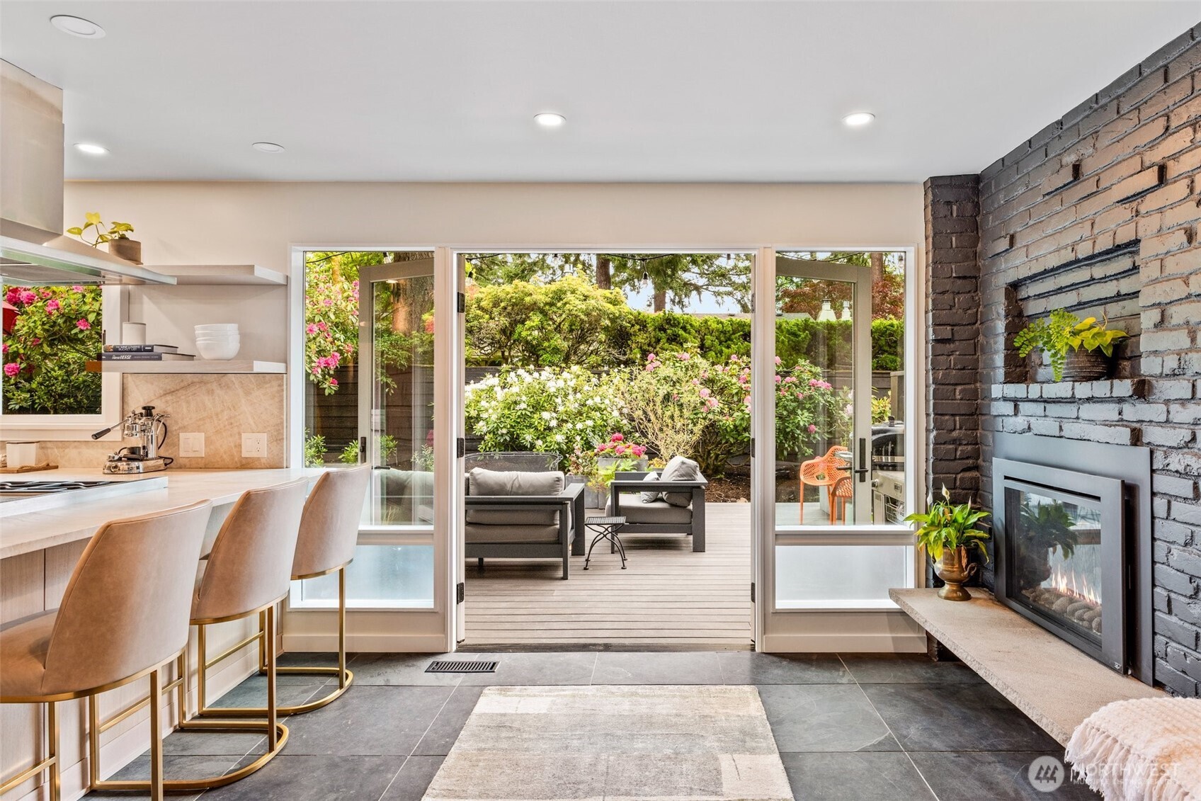 13526 Northshire Road Northwest Seattle, WA 98177 - Photo 15 of 40 a living room with furniture a fireplace and a floor to ceiling window