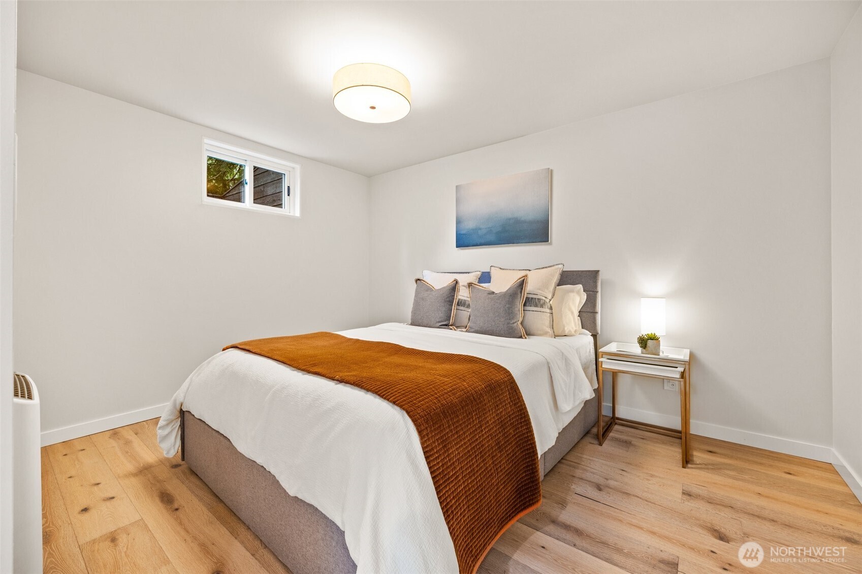 13526 Northshire Road Northwest Seattle, WA 98177 - Photo 26 of 40 a bedroom with a bed and wooden floor