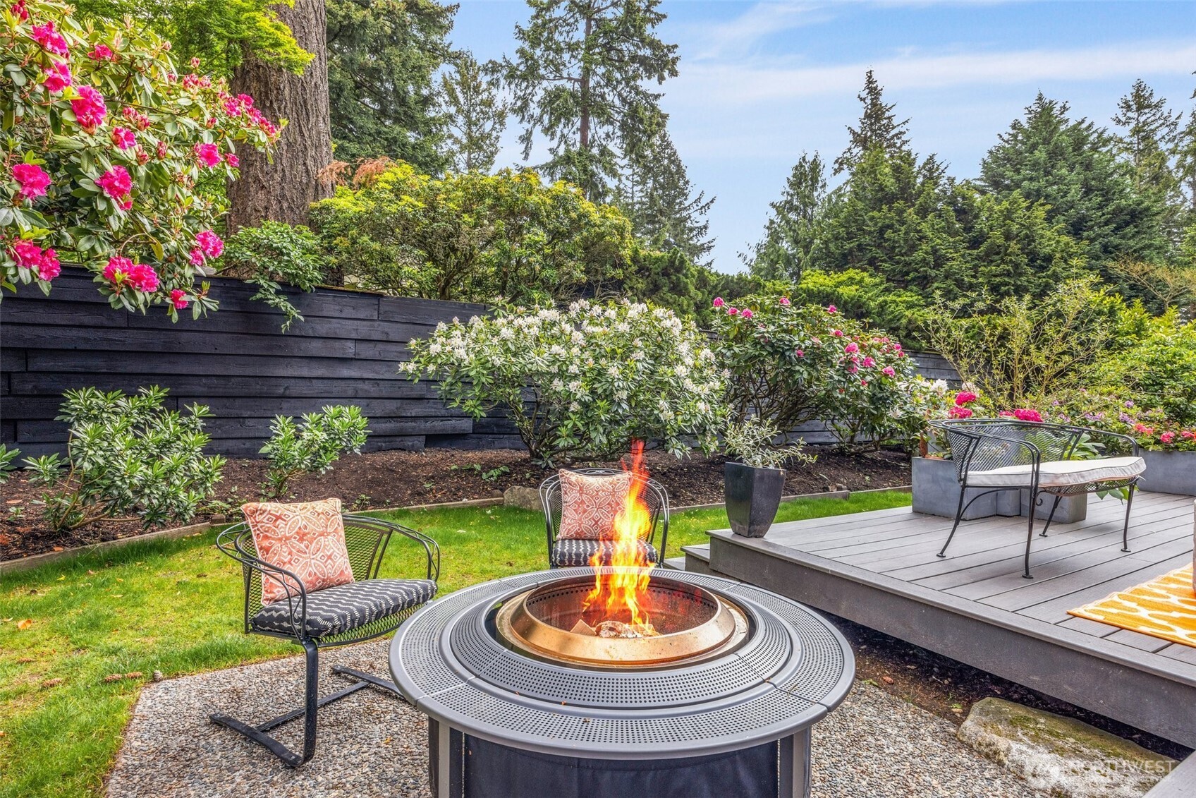 13526 Northshire Road Northwest Seattle, WA 98177 - Photo 33 of 40 a wooden table and chairs in a garden