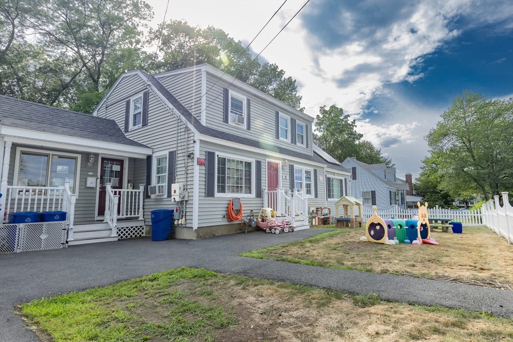 25 Beaconsfield Street Lawrence, MA 01843 - Photo 18 of 36 a front view of a house with a yard and outdoor seating