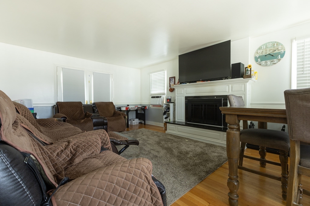 25 Beaconsfield Street Lawrence, MA 01843 - Photo 21 of 36 a living room with furniture a flat screen tv and a fireplace