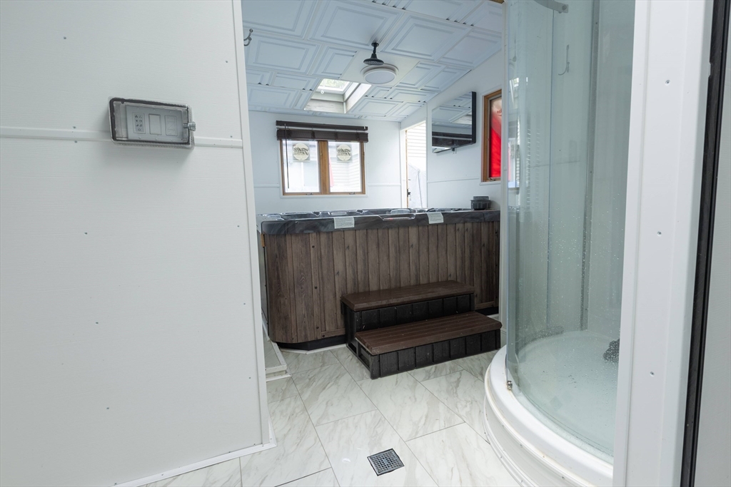 25 Beaconsfield Street Lawrence, MA 01843 - Photo 25 of 36 a bathroom with a tub sink and mirror