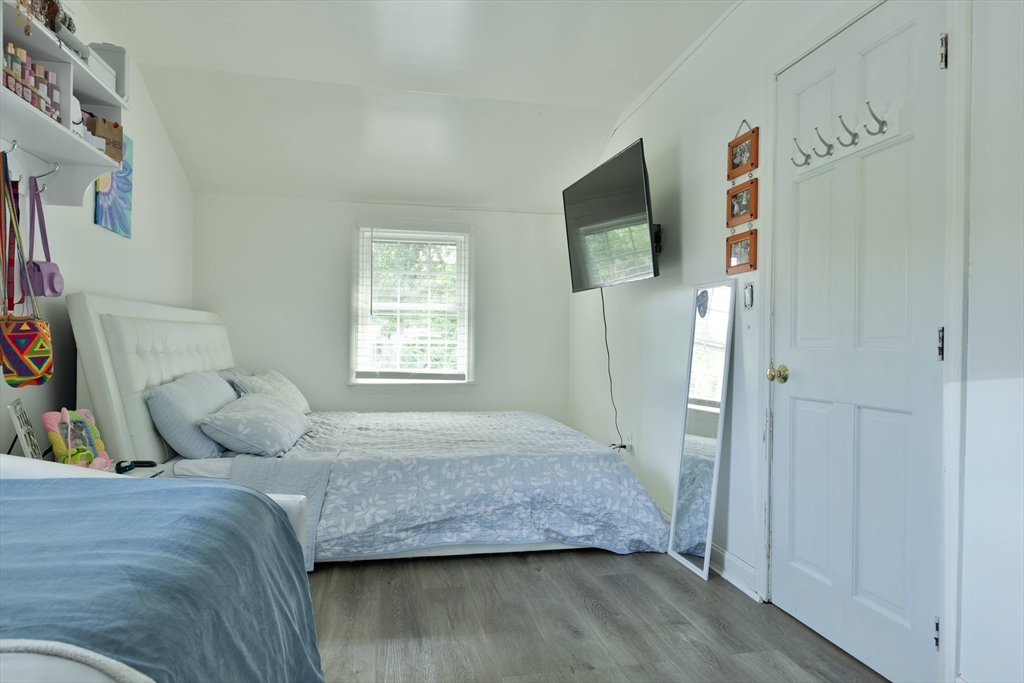 25 Beaconsfield Street Lawrence, MA 01843 - Photo 28 of 36 a bedroom with a bed and wooden floor