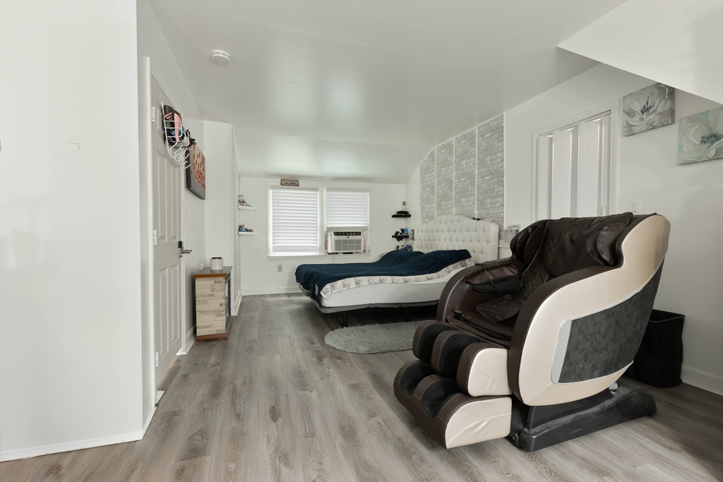 25 Beaconsfield Street Lawrence, MA 01843 - Photo 29 of 36 a living room with furniture and a wooden floor