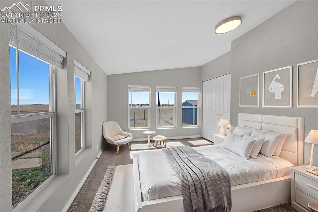 515 South Calhan Highway Yoder, CO 80864 - Photo 11 of 34 a spacious bedroom with a bed and glass door