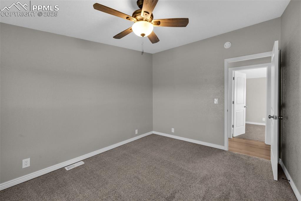 515 South Calhan Highway Yoder, CO 80864 - Photo 14 of 34 an empty room with closet and a chandelier fan