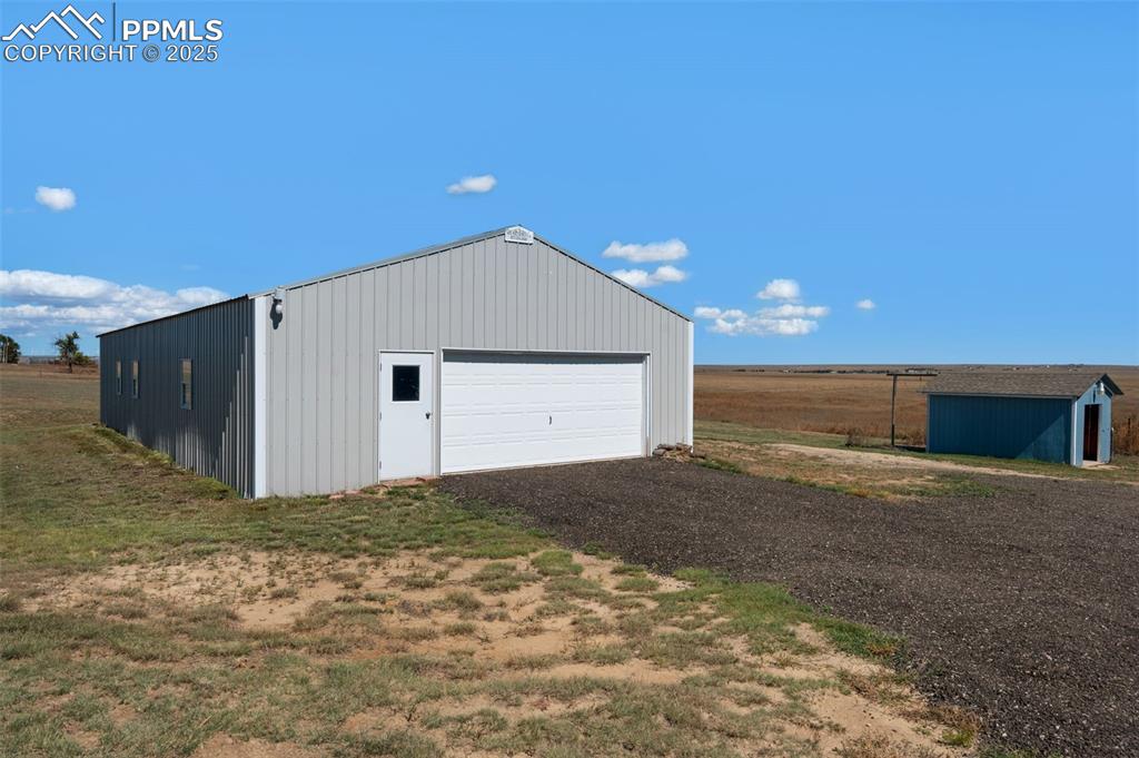 515 South Calhan Highway Yoder, CO 80864 - Photo 19 of 34 a backyard of a house with yard and garage