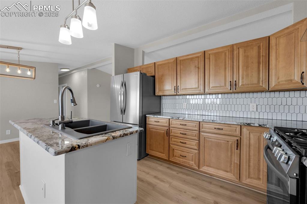 515 South Calhan Highway Yoder, CO 80864 - Photo 2 of 34 a kitchen with stainless steel appliances granite countertop a sink stove and refrigerator