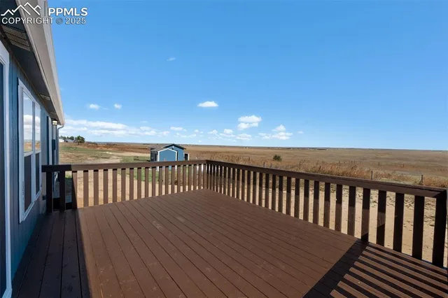 a view of wooden balcony with wooden floor