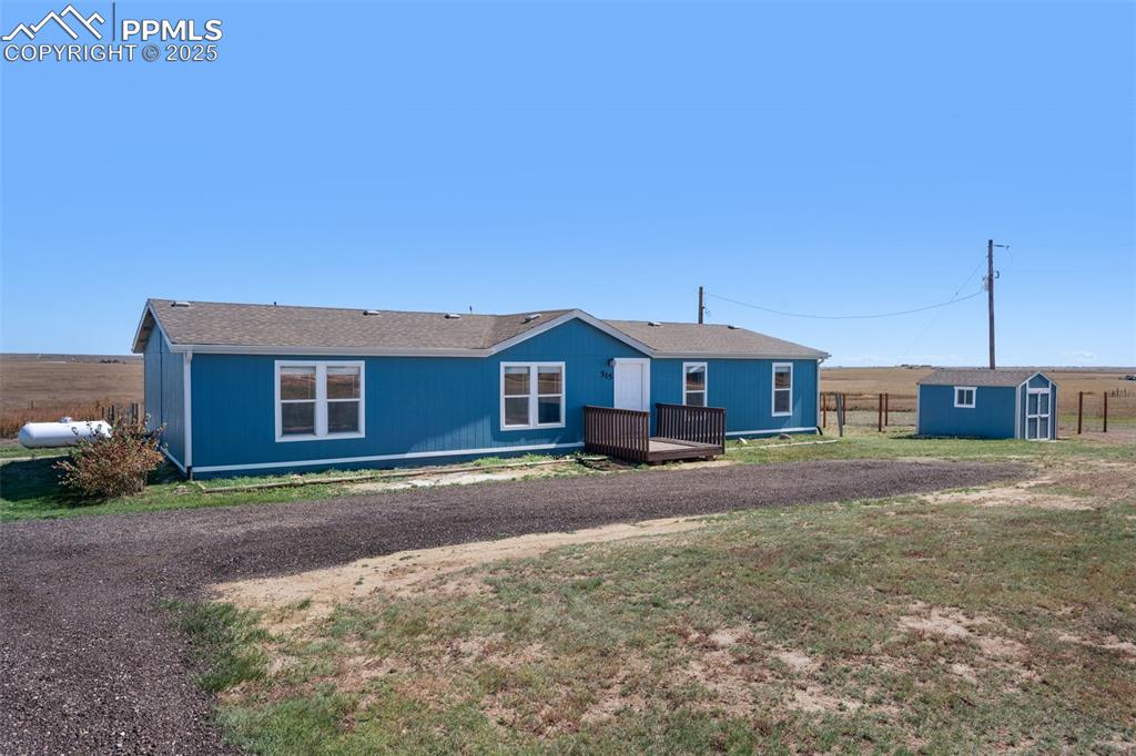 515 South Calhan Highway Yoder, CO 80864 - Photo 30 of 34 a front view of a house with a yard