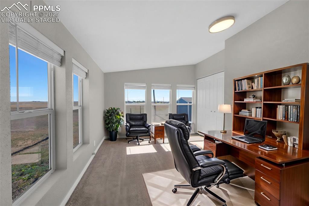 515 South Calhan Highway Yoder, CO 80864 - Photo 4 of 34 a view of a workspace with furniture and a bookshelf