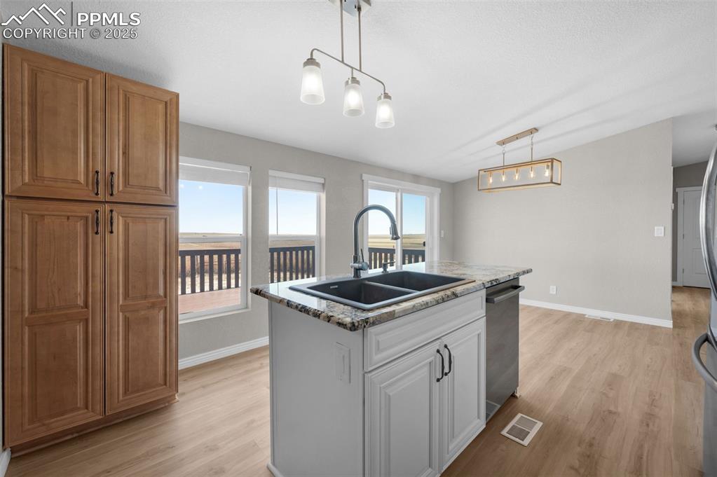 515 South Calhan Highway Yoder, CO 80864 - Photo 5 of 34 a kitchen with stainless steel appliances granite countertop a stove and a sink