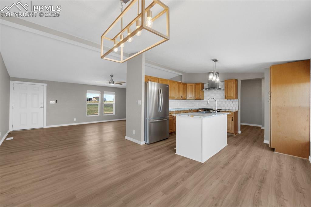 515 South Calhan Highway Yoder, CO 80864 - Photo 8 of 34 a view of kitchen with cabinets stainless steel appliances and wooden floor