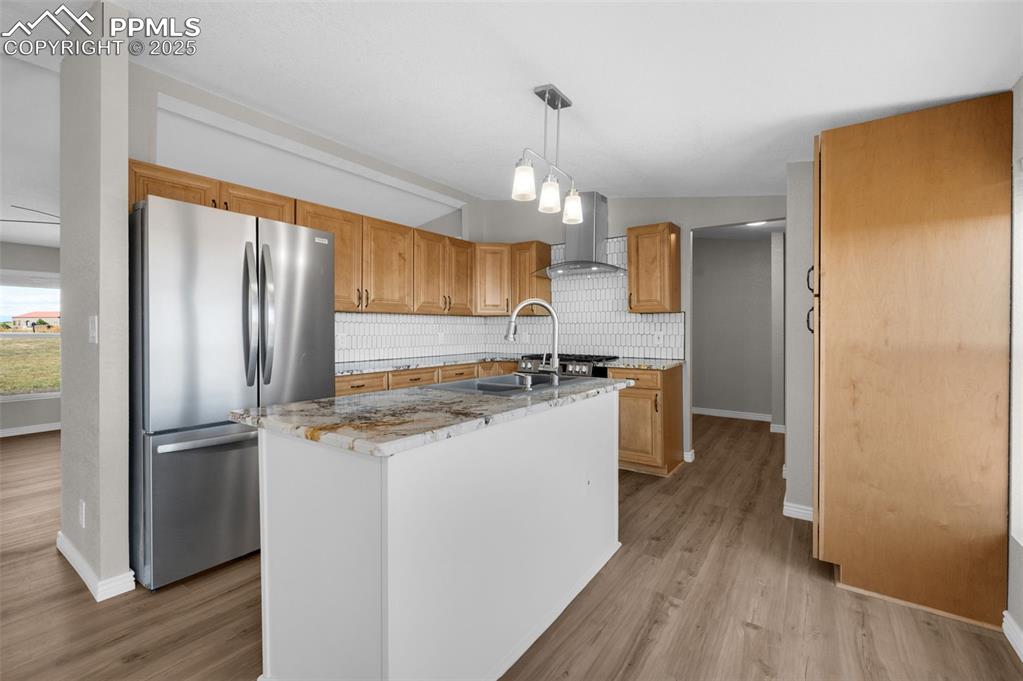 515 South Calhan Highway Yoder, CO 80864 - Photo 9 of 34 a kitchen with a refrigerator a sink and wooden floor
