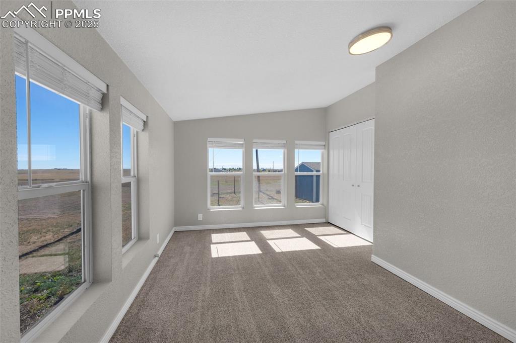 515 South Calhan Highway Yoder, CO 80864 - Photo 10 of 34 wooden floor in an empty room with a window