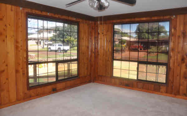 4875 Moi Road Hanapepe, HI 96716 - Photo 8 of 25 a view of an empty room with windows and chandelier fan