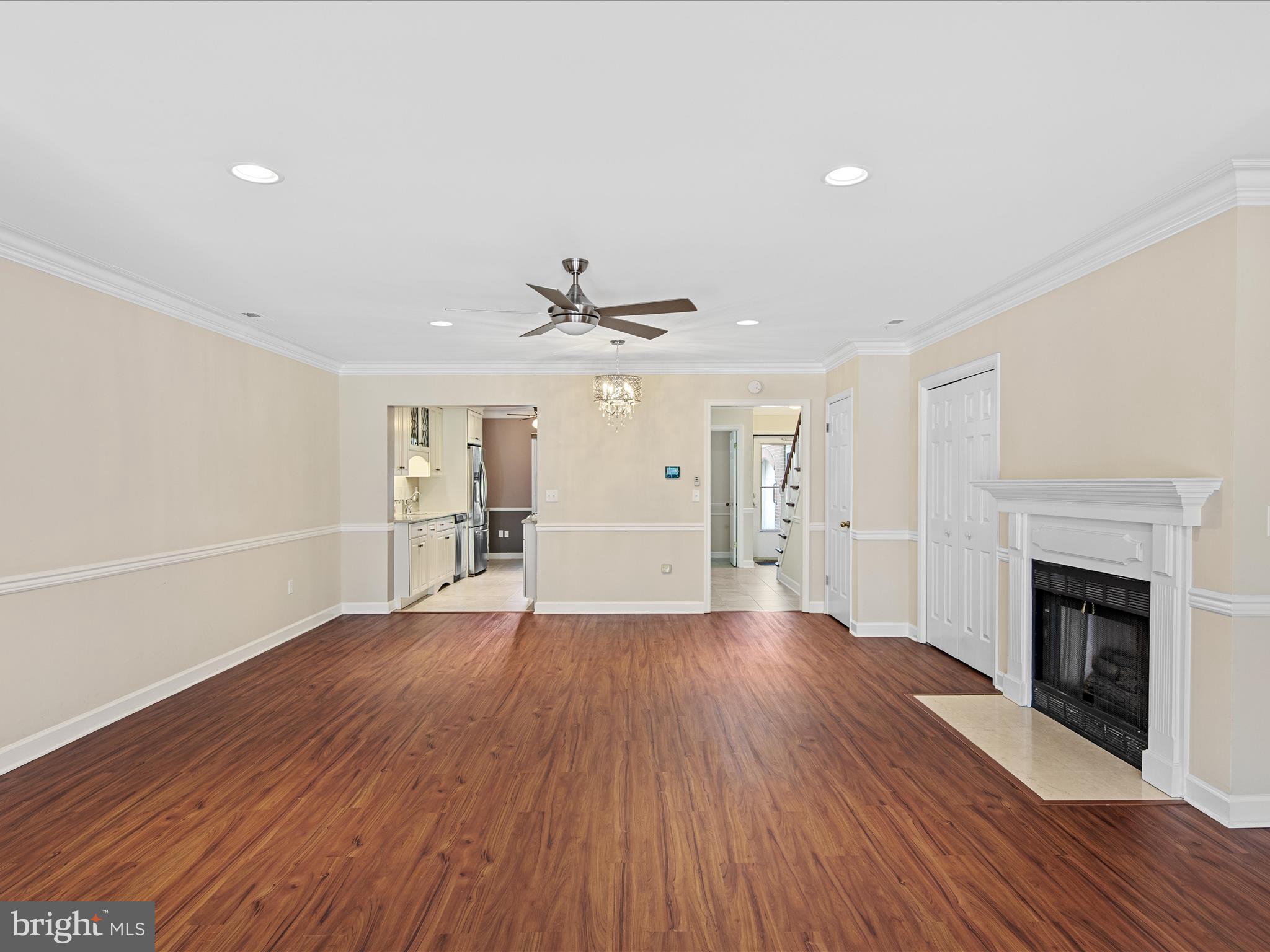 24345 Widgeon Place, Unit 29 St. Michaels, MD 21663 - Photo 12 of 38 an empty room with wooden floor fireplace and windows
