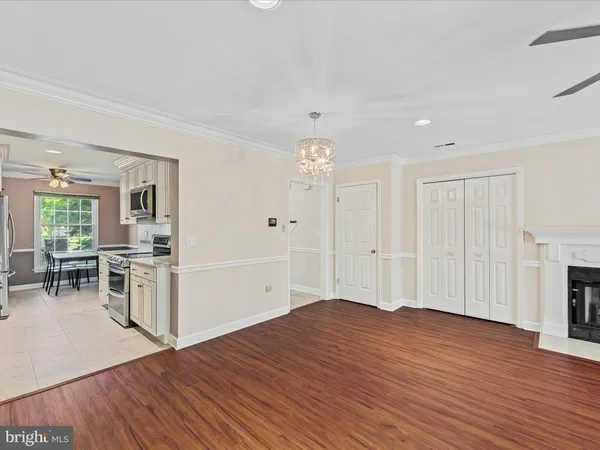 a view of a kitchen with furniture and wooden floor