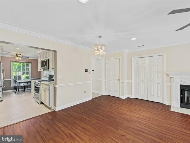 a view of a kitchen with furniture and wooden floor