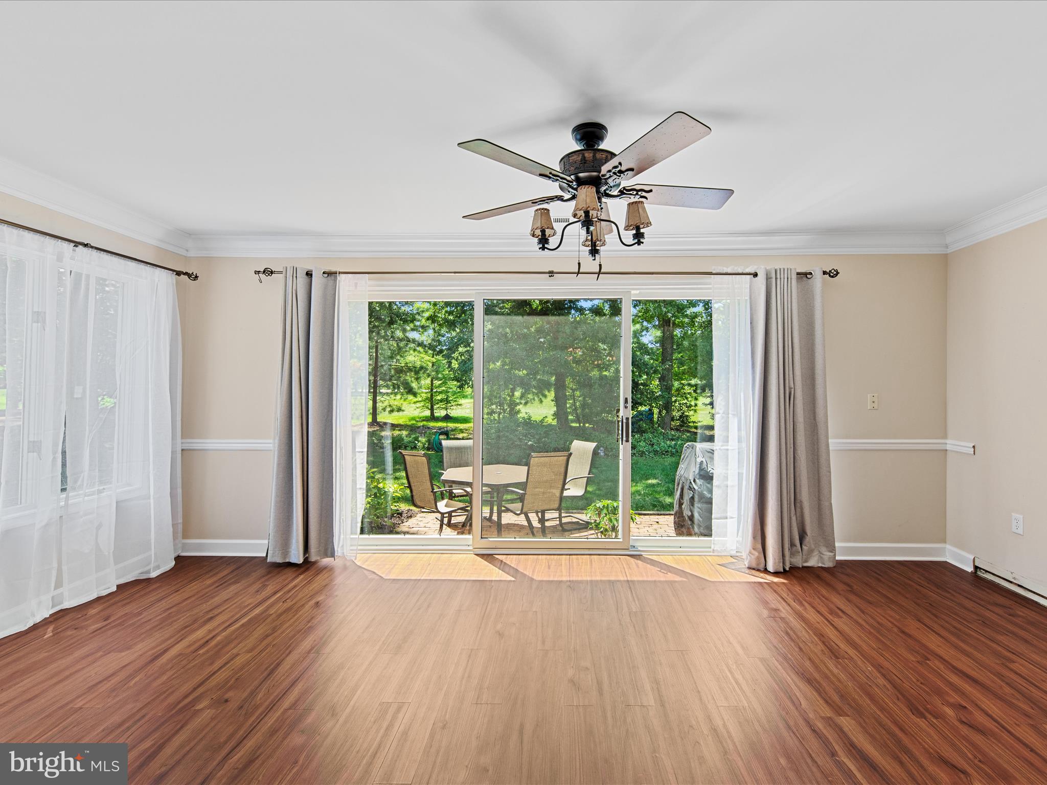 24345 Widgeon Place, Unit 29 St. Michaels, MD 21663 - Photo 16 of 38 a view of a livingroom with a large window wooden floor and front door