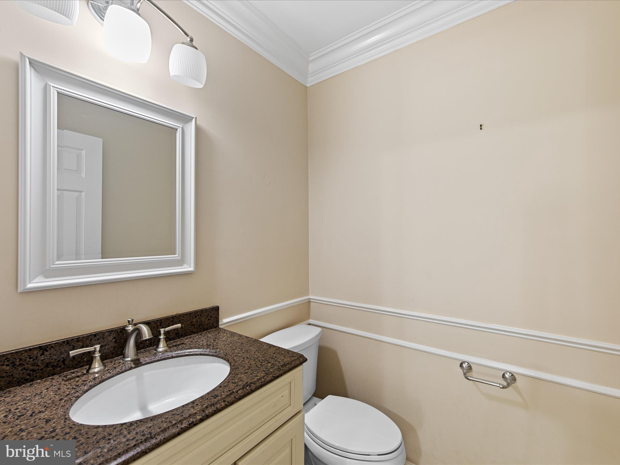 24345 Widgeon Place, Unit 29 St. Michaels, MD 21663 - Photo 19 of 38 a bathroom with a granite countertop sink mirror vanity and toilet