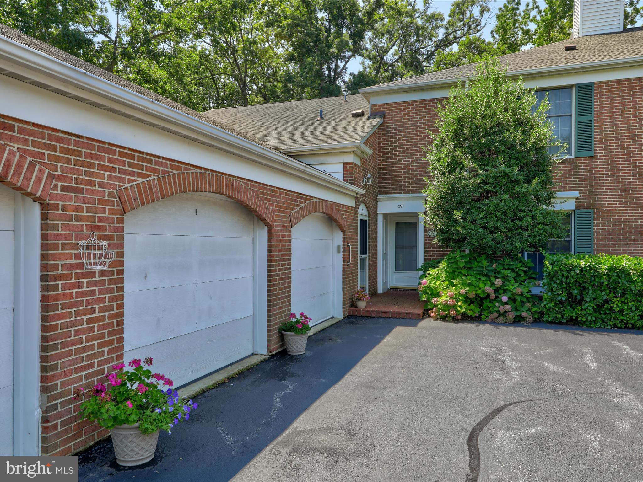 24345 Widgeon Place, Unit 29 St. Michaels, MD 21663 - Photo 2 of 38 a front view of a house with a yard
