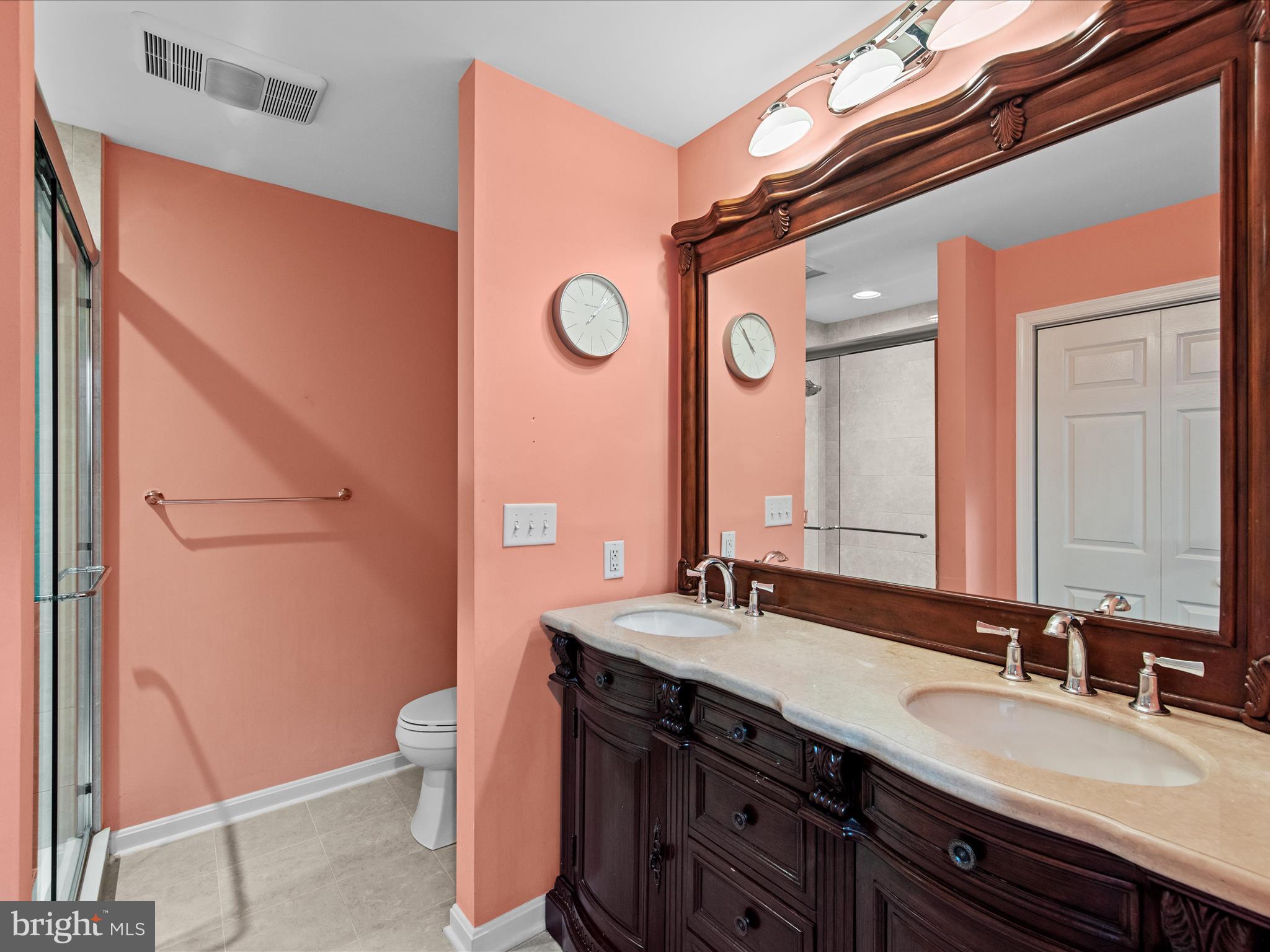 24345 Widgeon Place, Unit 29 St. Michaels, MD 21663 - Photo 24 of 38 a bathroom with a granite countertop sink mirror vanity and toilet
