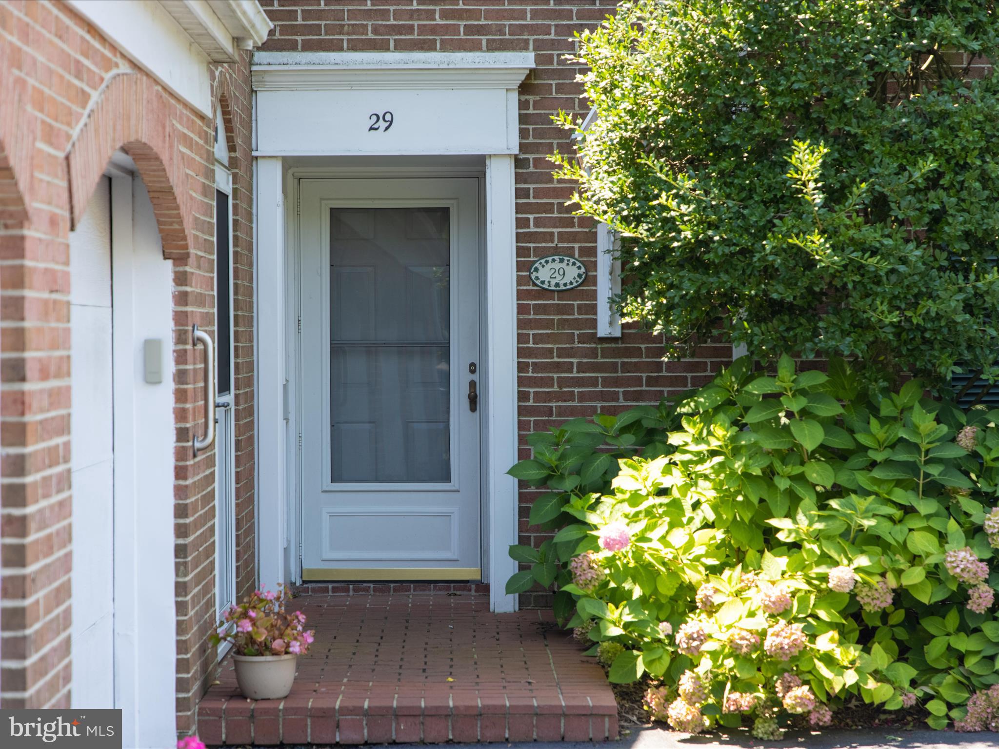 24345 Widgeon Place, Unit 29 St. Michaels, MD 21663 - Photo 3 of 38 a front view of a house with a garden
