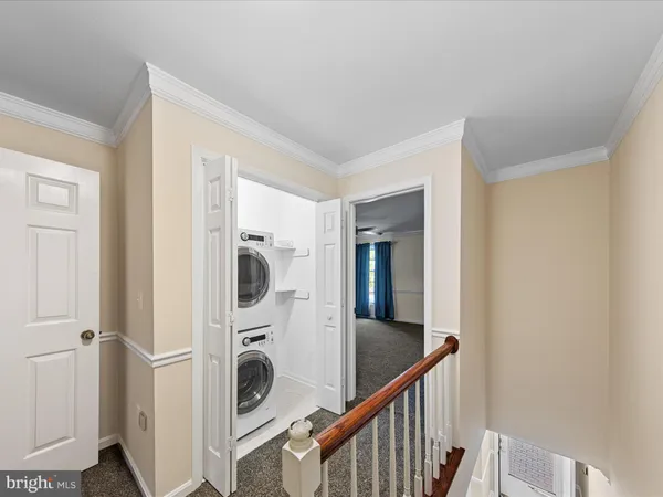 a view of a hallway with washer and dryer